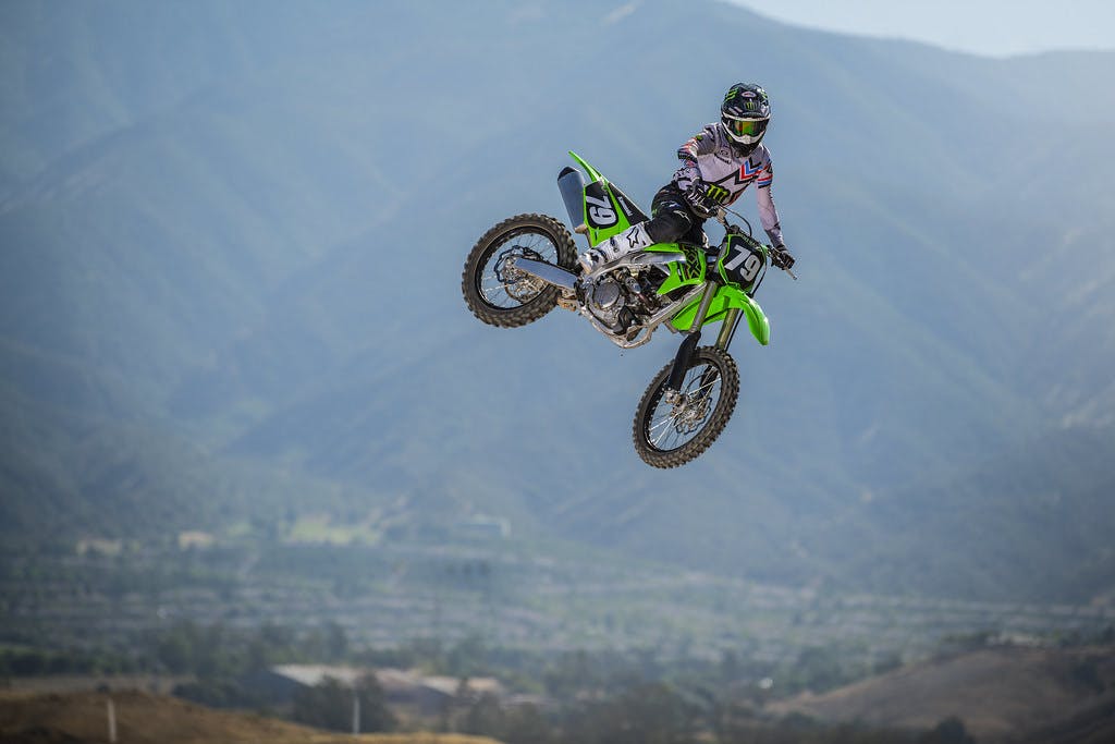 KawasakiI KX250 in lime green colour on off-road track