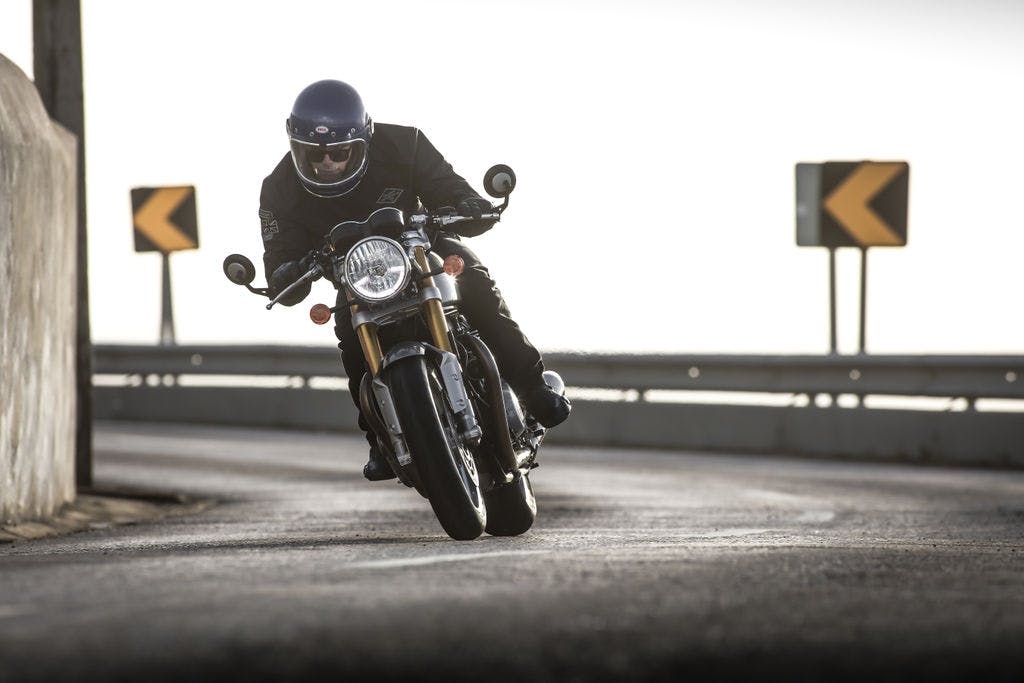 TRIUMPH THRUXTON 1200 R being ridden on the hill road