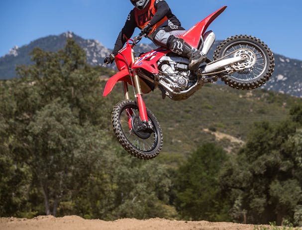 Honda CRF450R in extreme red colour being ridden on off road track
