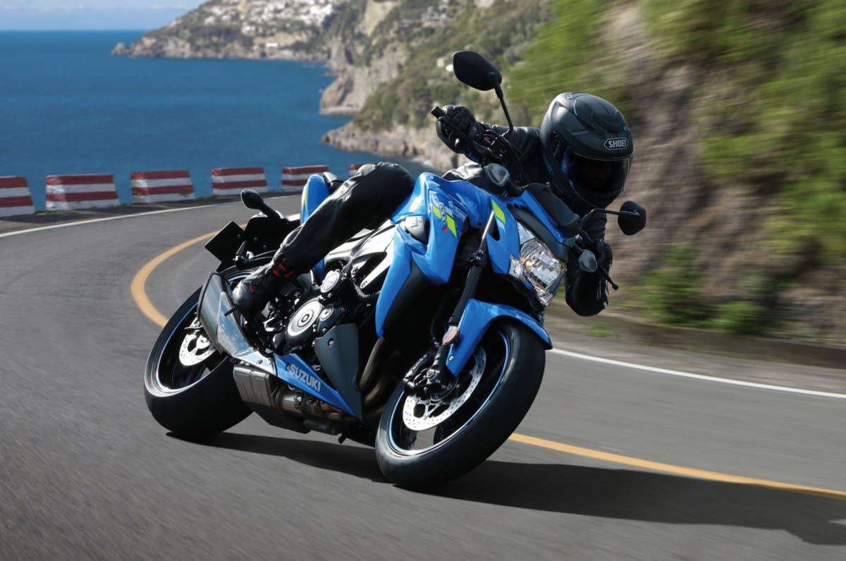 SUZUKI GSX-S1000 being ridden on a road