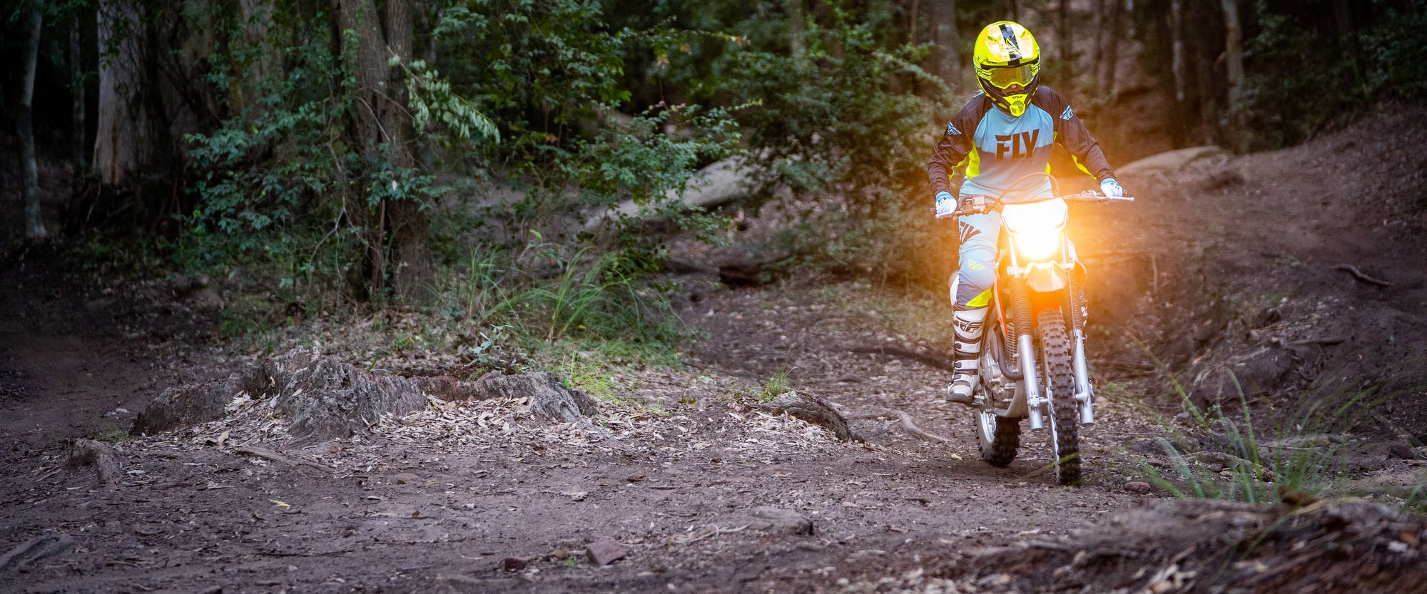 Honda CRF250F in extreme red colour being ridden on off road track