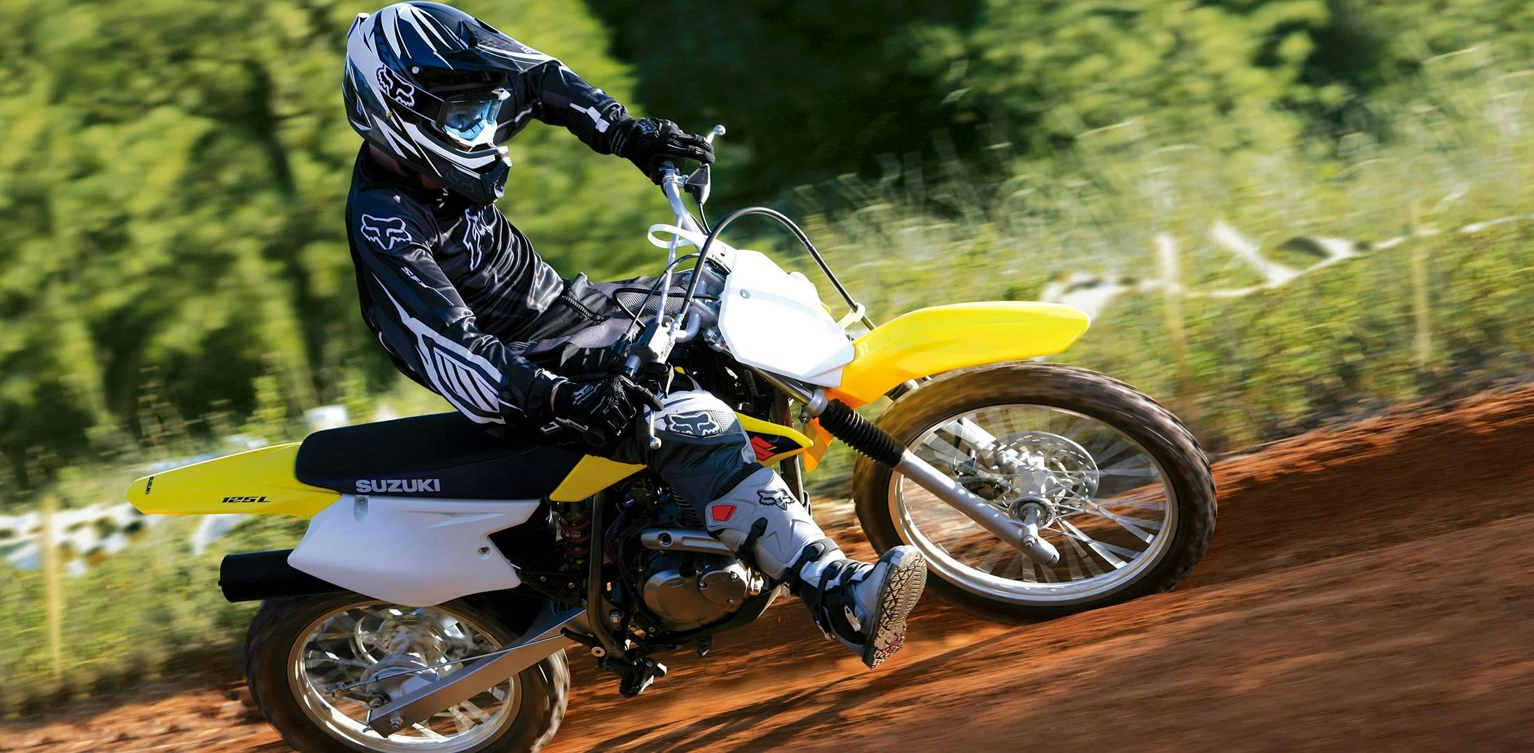 SUZUKI DR-Z125 in champion yellow colour on off road track