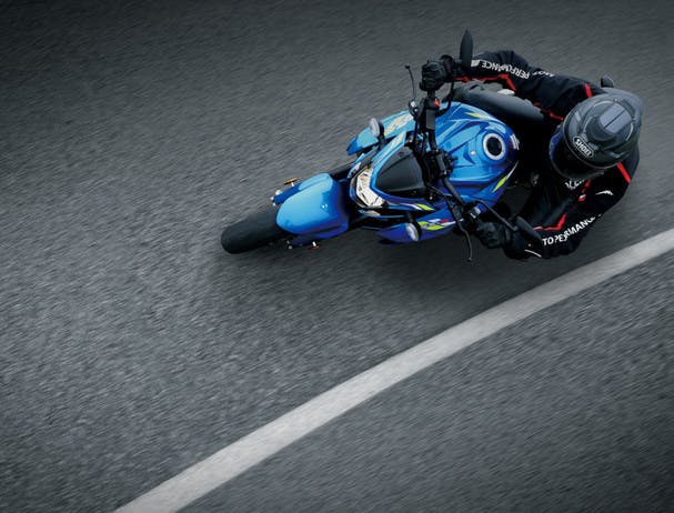 SUZUKI GSX-S750 being ridden on a road