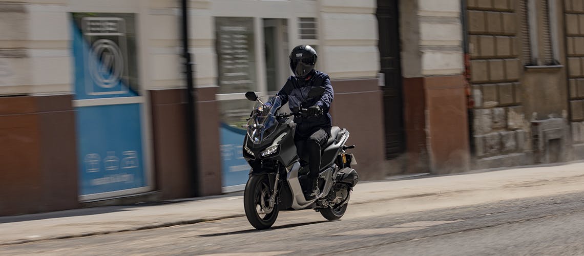 Honda ADV150 in Matte Black Metallic colour on the road