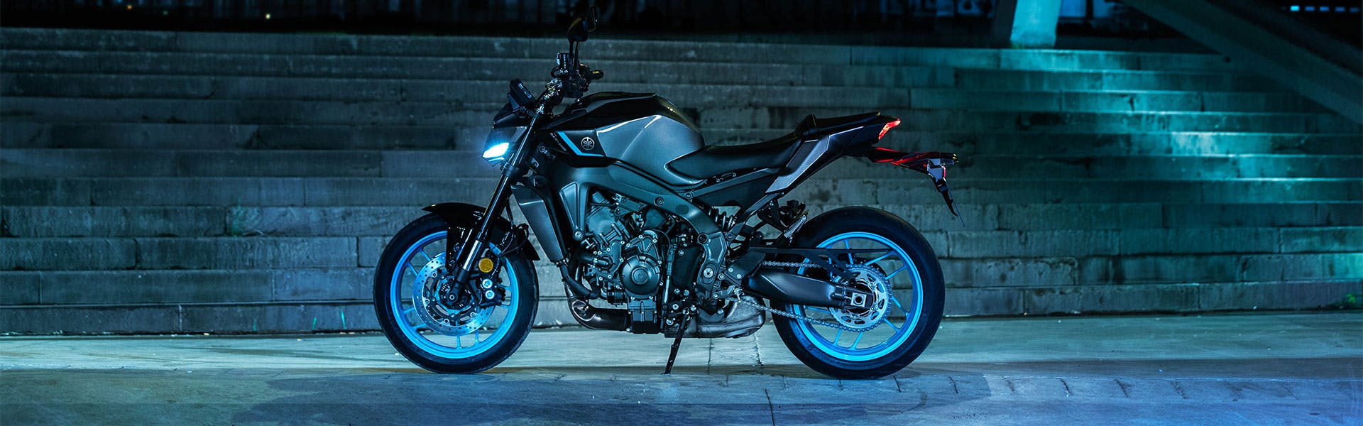 Yamaha MT-09 in cyan colour on the road.