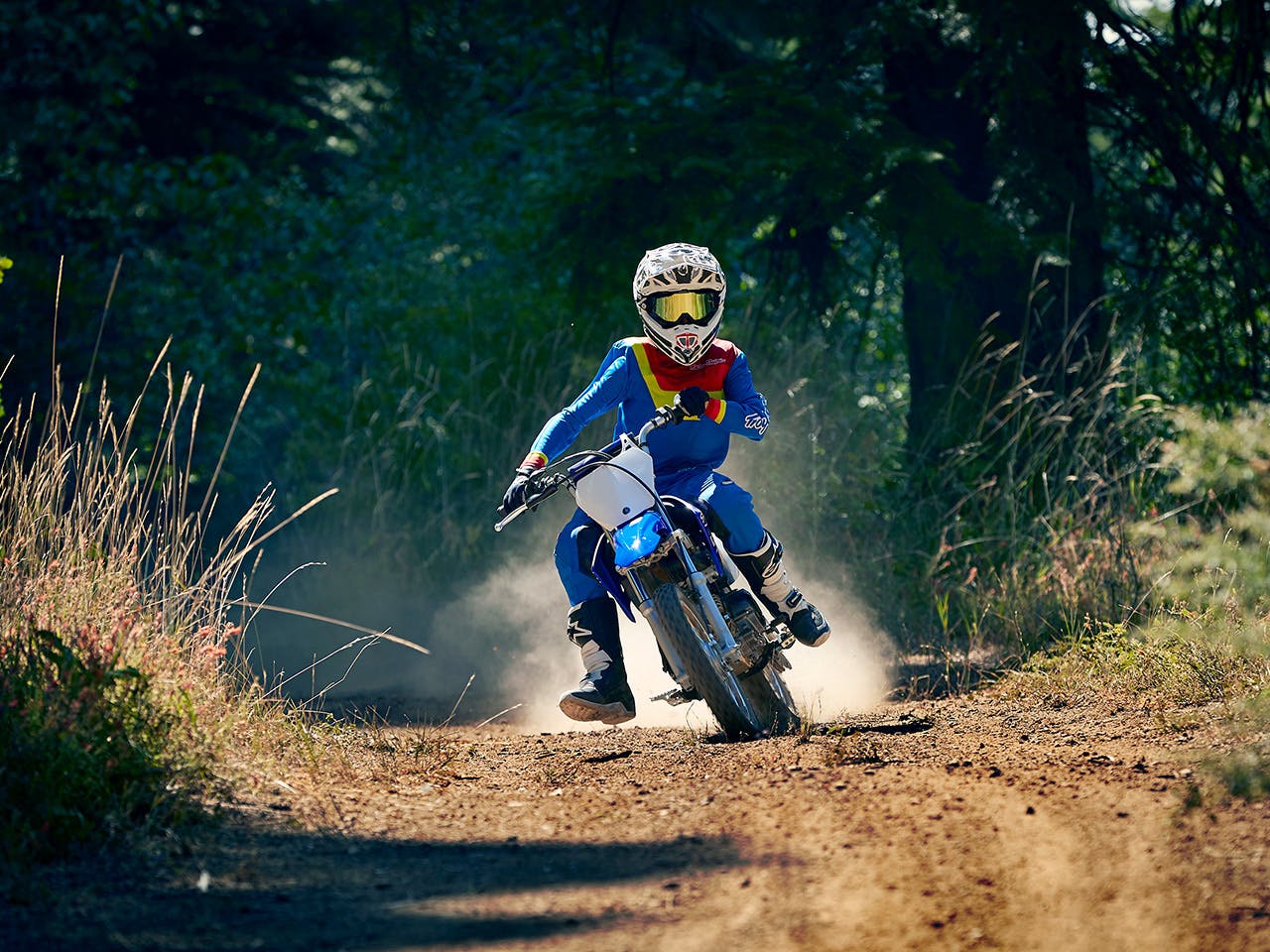 Yamaha TT-R110E in Team Yamaha Blue and White colour, being ridden off-track