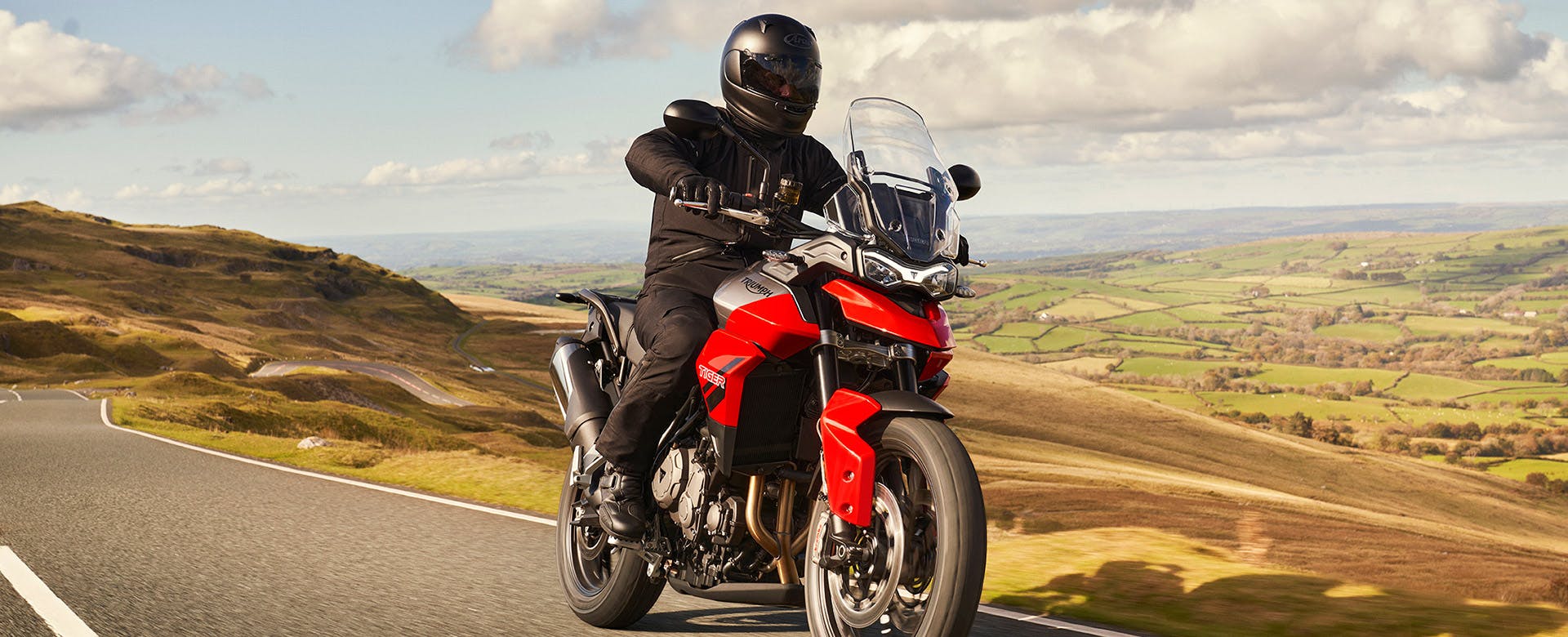 Triumph Tiger 850 in graphite diablo red colour on the road