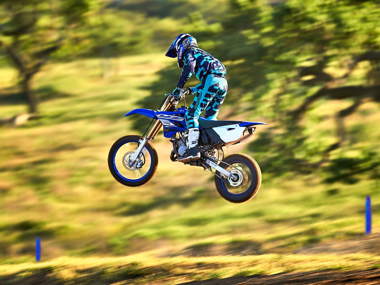 Yamaha YZ85 in team yamaha blue and white colour, being ridden off-track