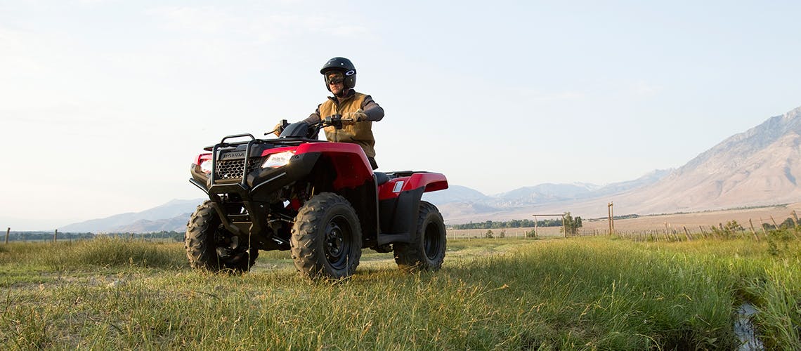 Honda TRX420TM1, being ridden on the farm