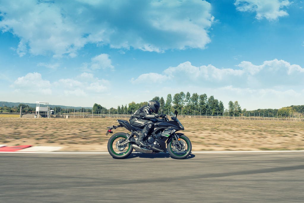 KAWASAKI NINJA 650L in metallic spark black colour, being ridden on a road