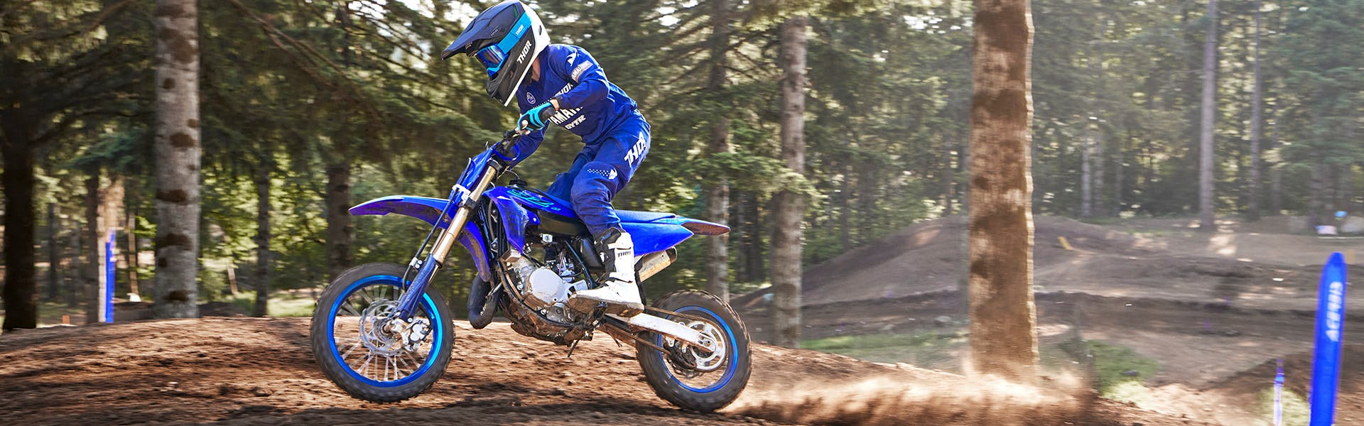 Yamaha YZ65 in team yamaha blue colour , being ridden off-track