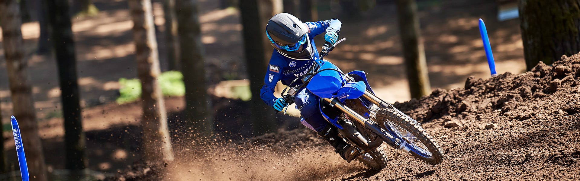 Yamaha YZ85 in team yamaha blue colour, being ridden off-track