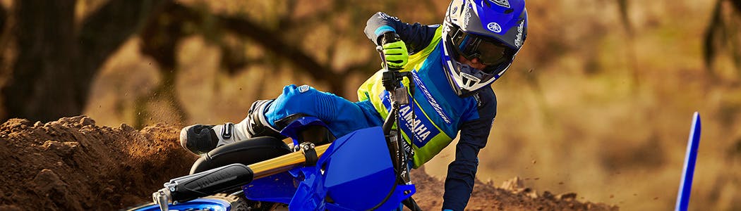 Yamaha YZ65 in team yamaha blue colour , being ridden off-track