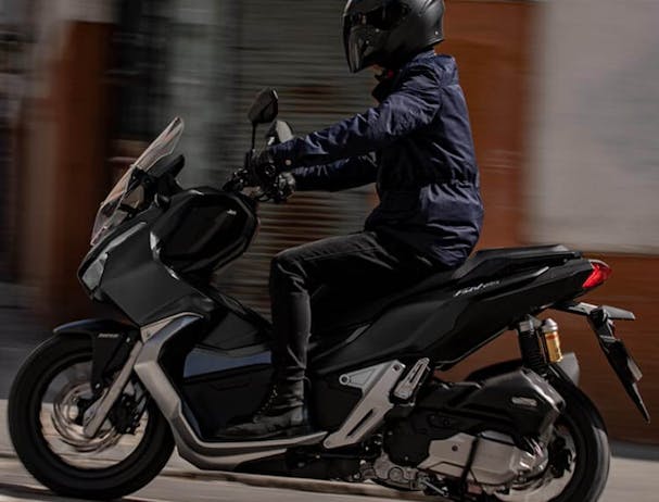 Honda ADV150 in Matte Black Metallic colour on the road