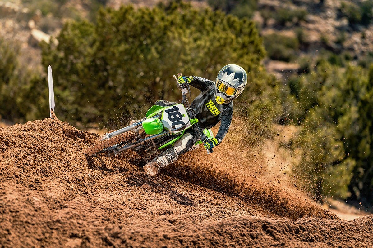 KAWASAKI KX65 in lime green colour on off-road track