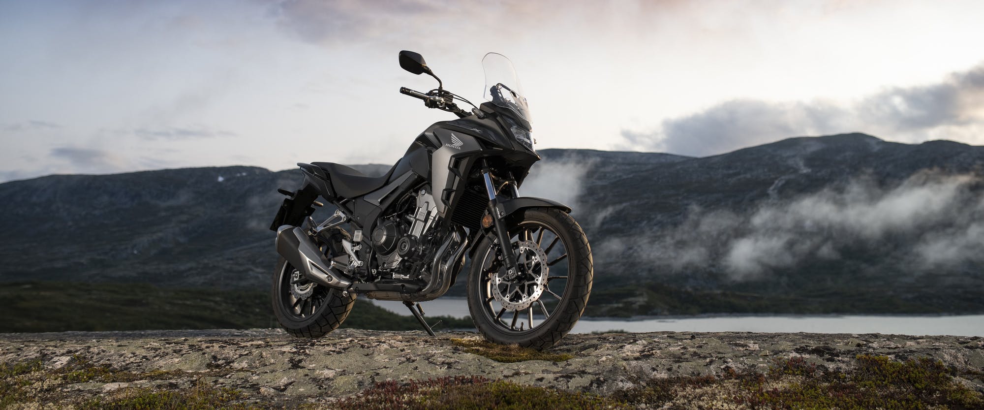 Honda CB500X in Matte Gunpowder Black Metallic colour, parked on off-road track