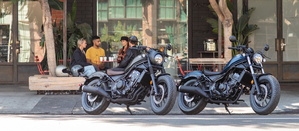 Two Honda CMX500, parked in front of a cafe