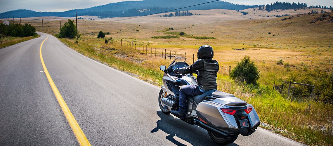 Honda 2018 Goldwing in matte majestic silver metallic colour, being ridden on the hill road