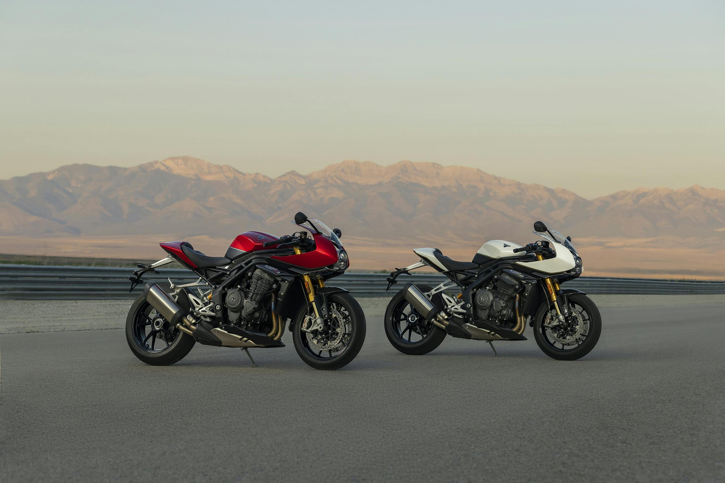 Triumph Speed Triple 1200 RR in crystal white and red hopper colours, parked.