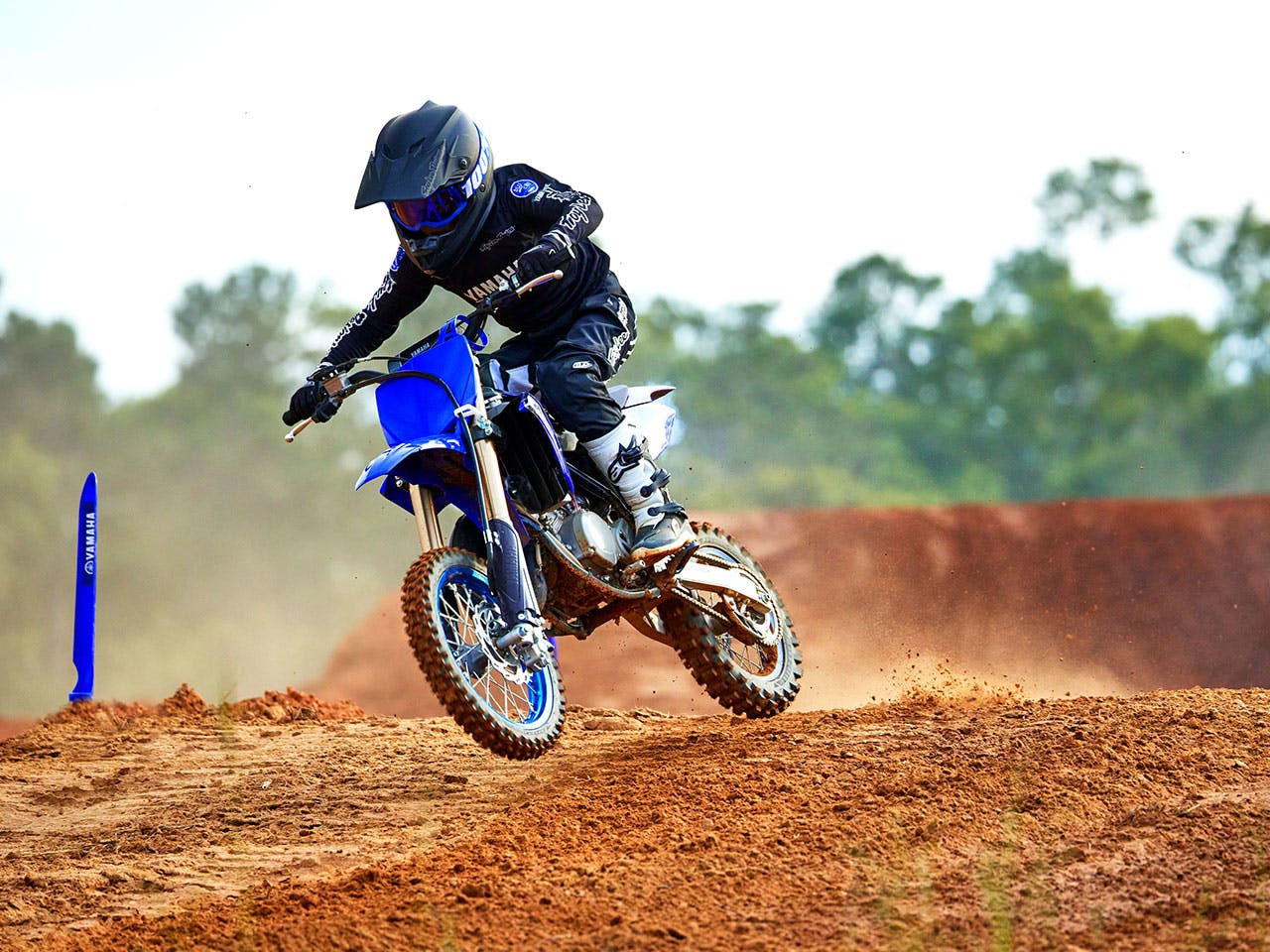 Yamaha YZ65 in team yamaha blue colour , being ridden off-track
