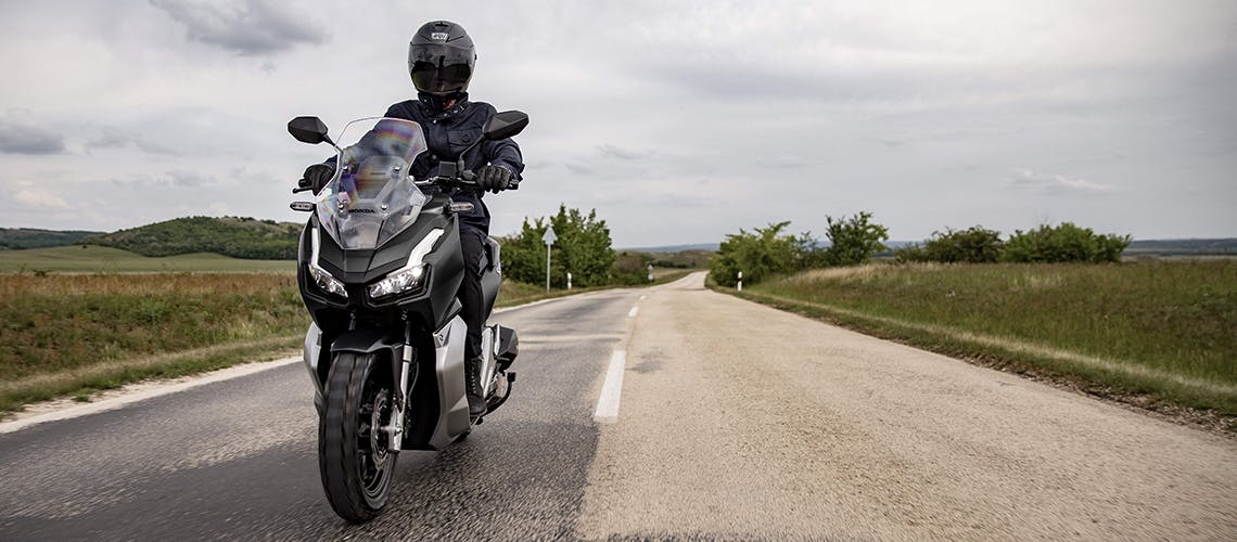 Honda ADV150 in Matte Black Metallic colour on the road