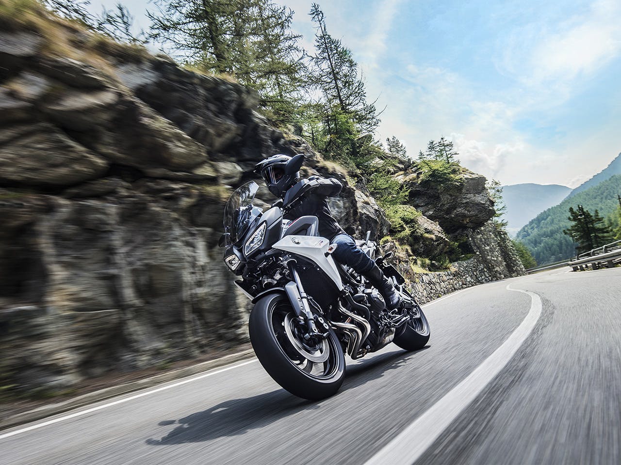 Yamaha Tracer 900 motorcycle riding on the hill road