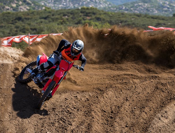 Honda CRF450R in extreme red colour being ridden on off road track