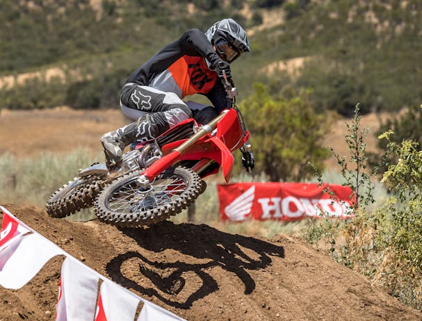 Honda CRF450R in extreme red colour being ridden on off road track