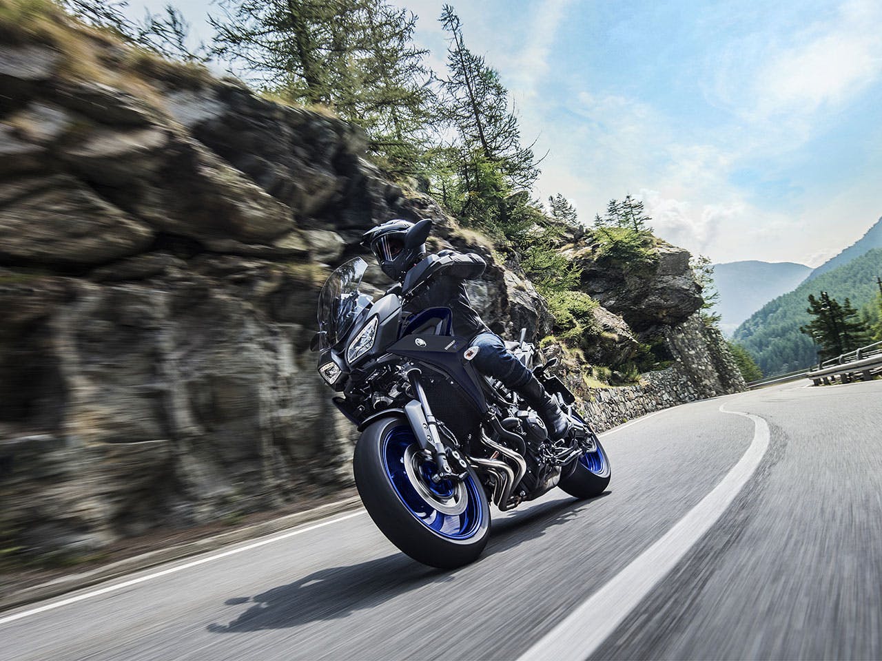 Yamaha Tracer 900 motorcycle riding on the hill road