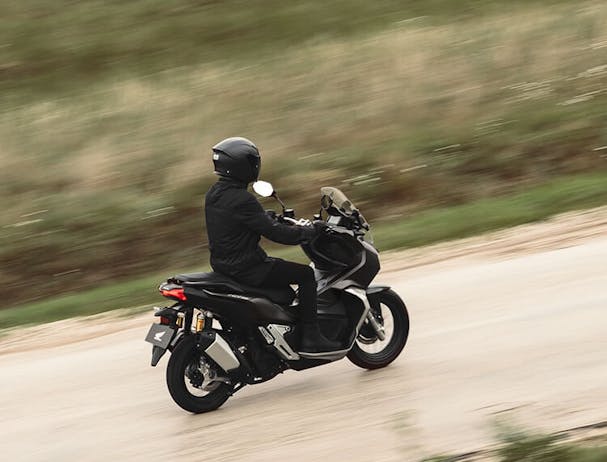 Honda ADV150 in Matte Black Metallic colour on the road