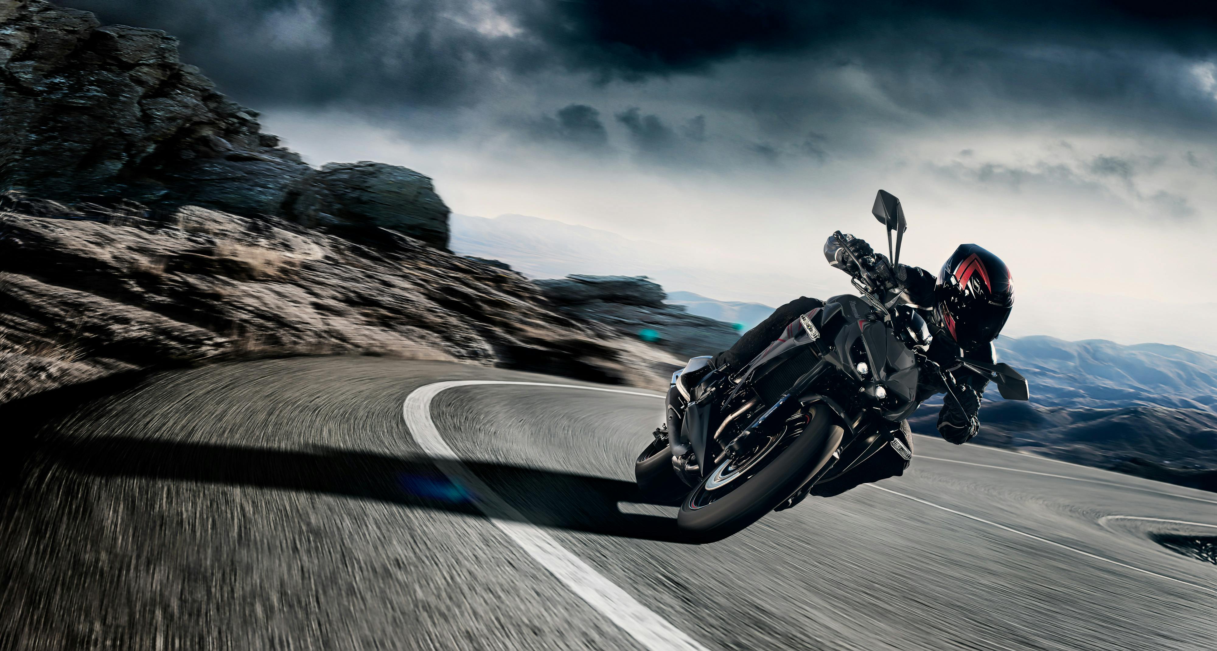 KAWASAKI Z1000 in metallic flat spark black and metallic matte graphite gray, colour being ridden on a hill road