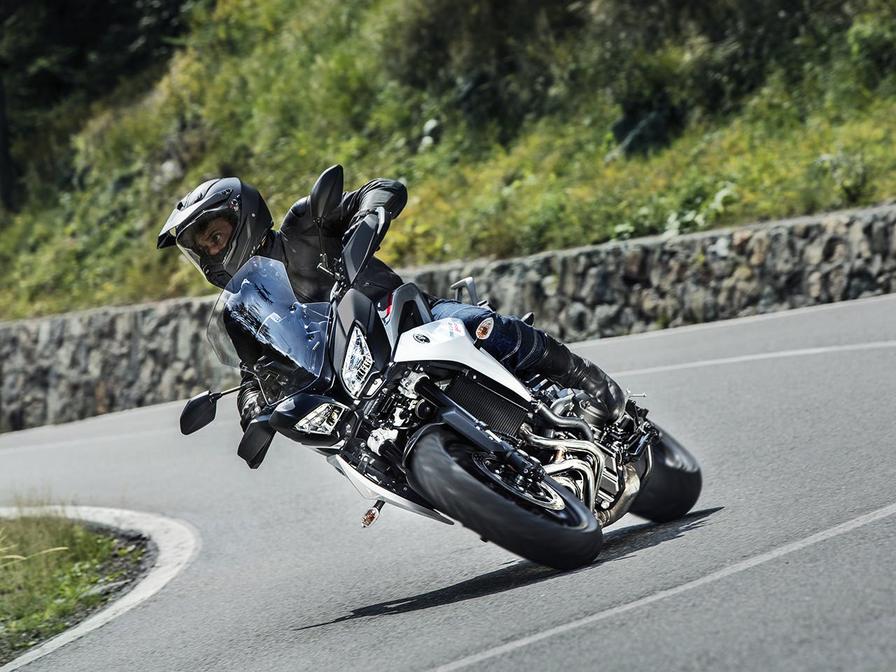 Yamaha Tracer 900 motorcycle riding on the hill road