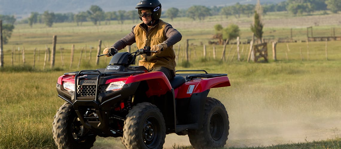 Honda TRX420TM1, being ridden on the farm