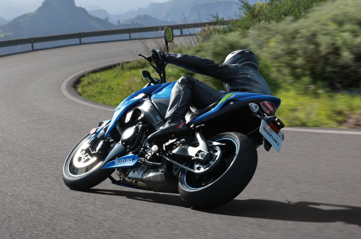 SUZUKI GSX-S1000 being ridden on a road