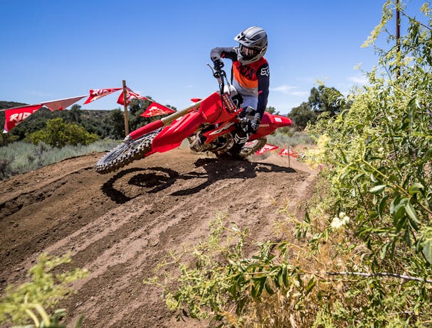Honda CRF450R in extreme red colour being ridden on off road track