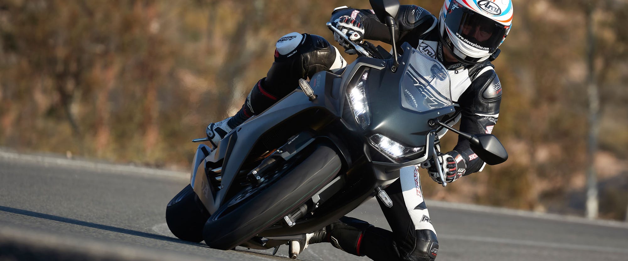 Honda CBR650R in pearl smoke grey colour, being ridden on the road