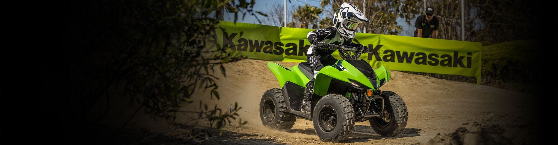 Kawasaki KFX90 in lime green colour on off road track
