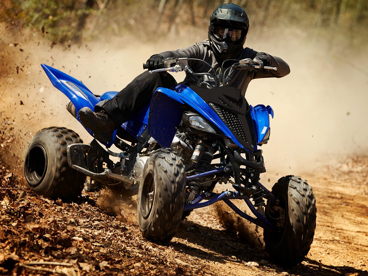 Yamaha YFM700R in team yamaha blue colour, being ridden off-track