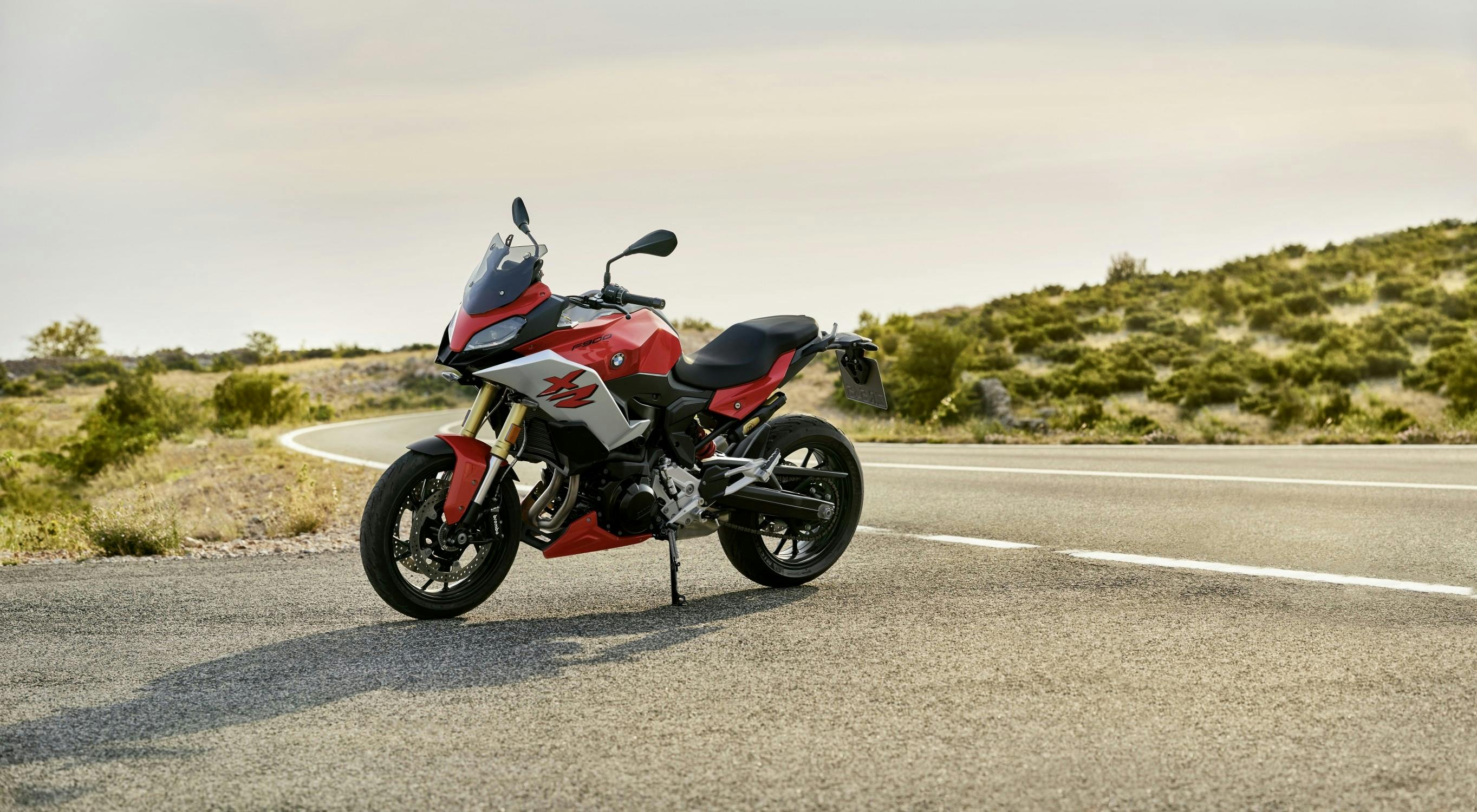 BMW F 900 XR in racing red colour parked on the road.