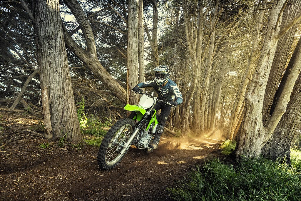 Kawasaki KLX230R in Lime Green colour going up the hill