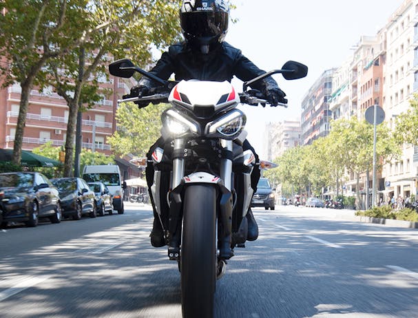 Triumph Street Triple S in crystal white colour on the road