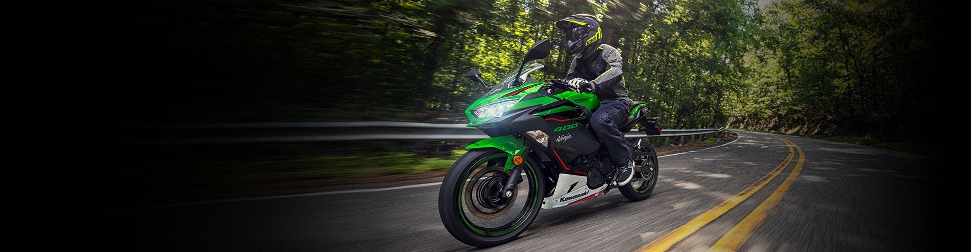 KAWASAKI NINJA 400 SE being ridden on a road