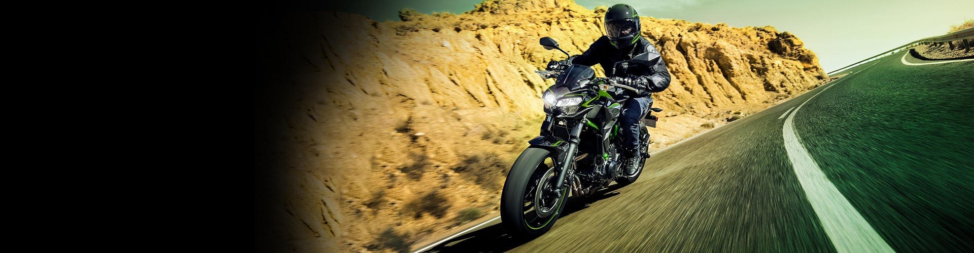 Kawasaki Z650 in Candy Lime Green with Metallic Spark Black colour on the road.