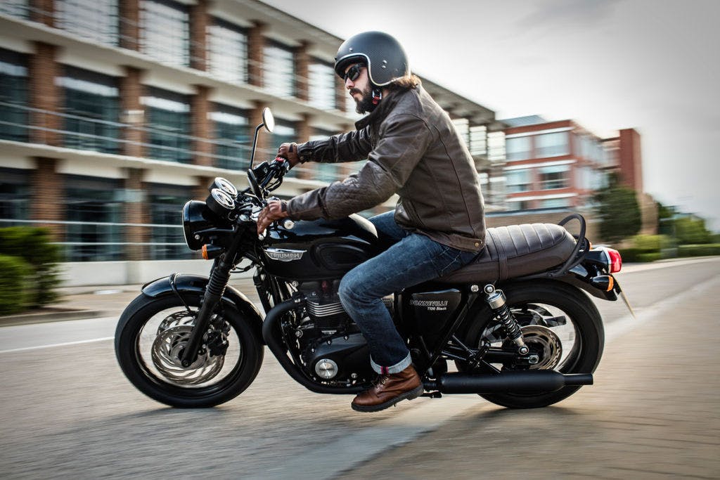 TRIUMPH Bonneville T120 Black being ridden on the road