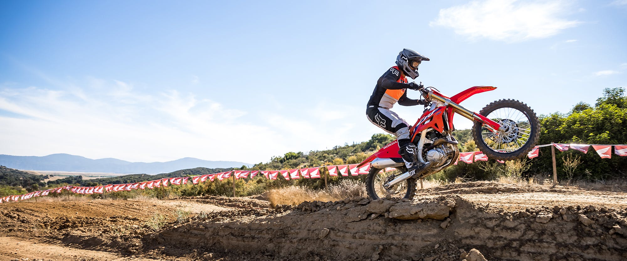 Honda CRF450R in extreme red colour being ridden on off road track
