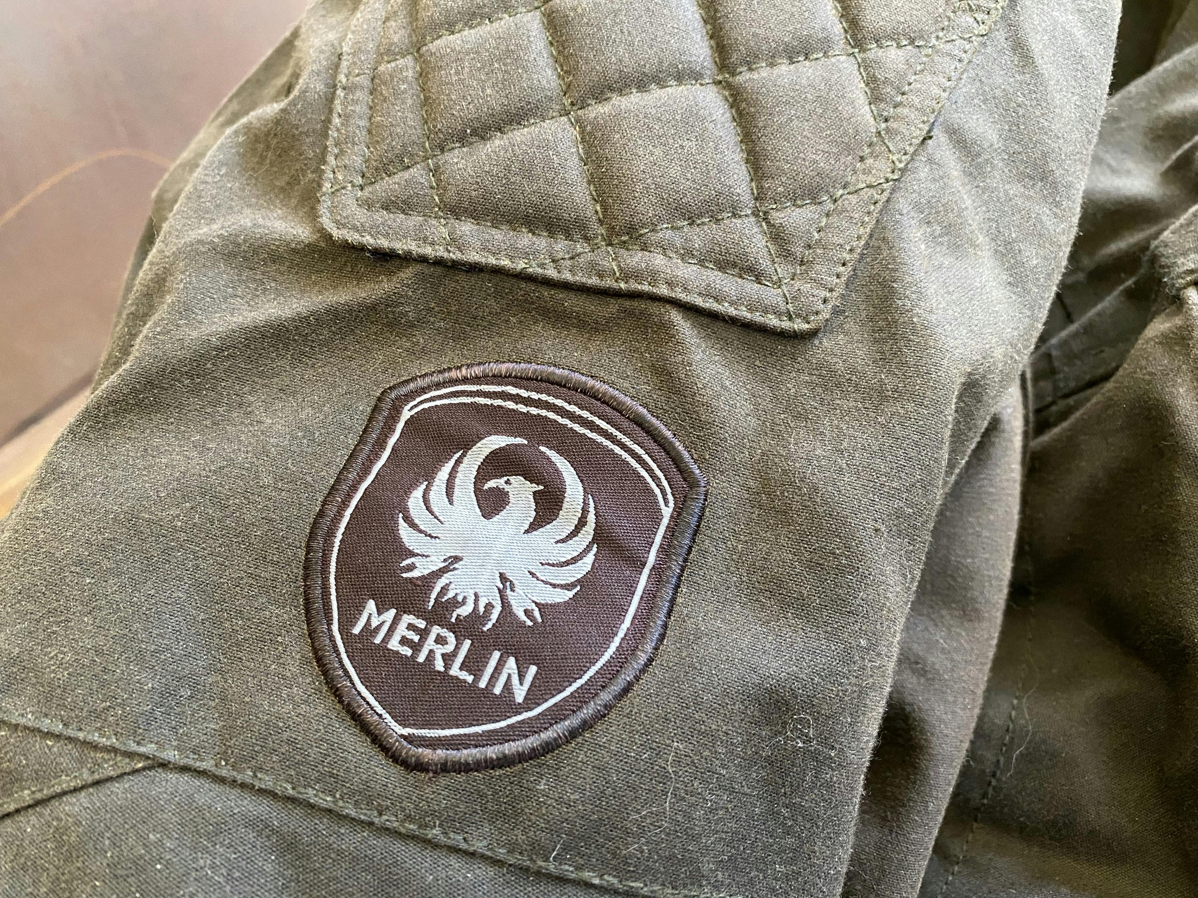 A close up of the shoulder quilting and merlin badge on the Merlin Barton jacket