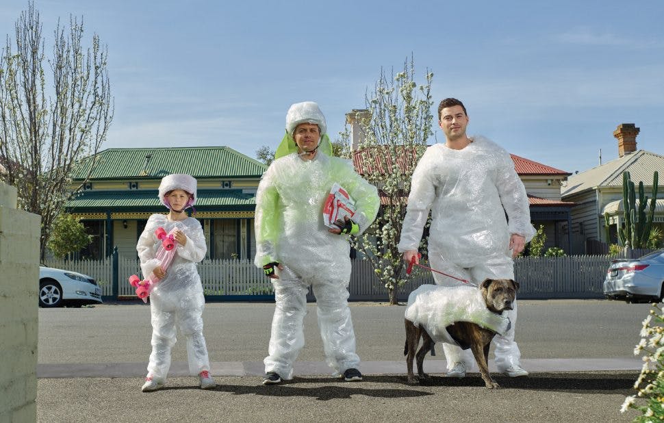 Family of 3 and a dog covered in bubblewrap