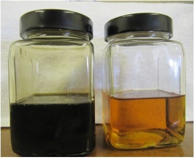a jar of dirty black oil and a jar of clean amber oil