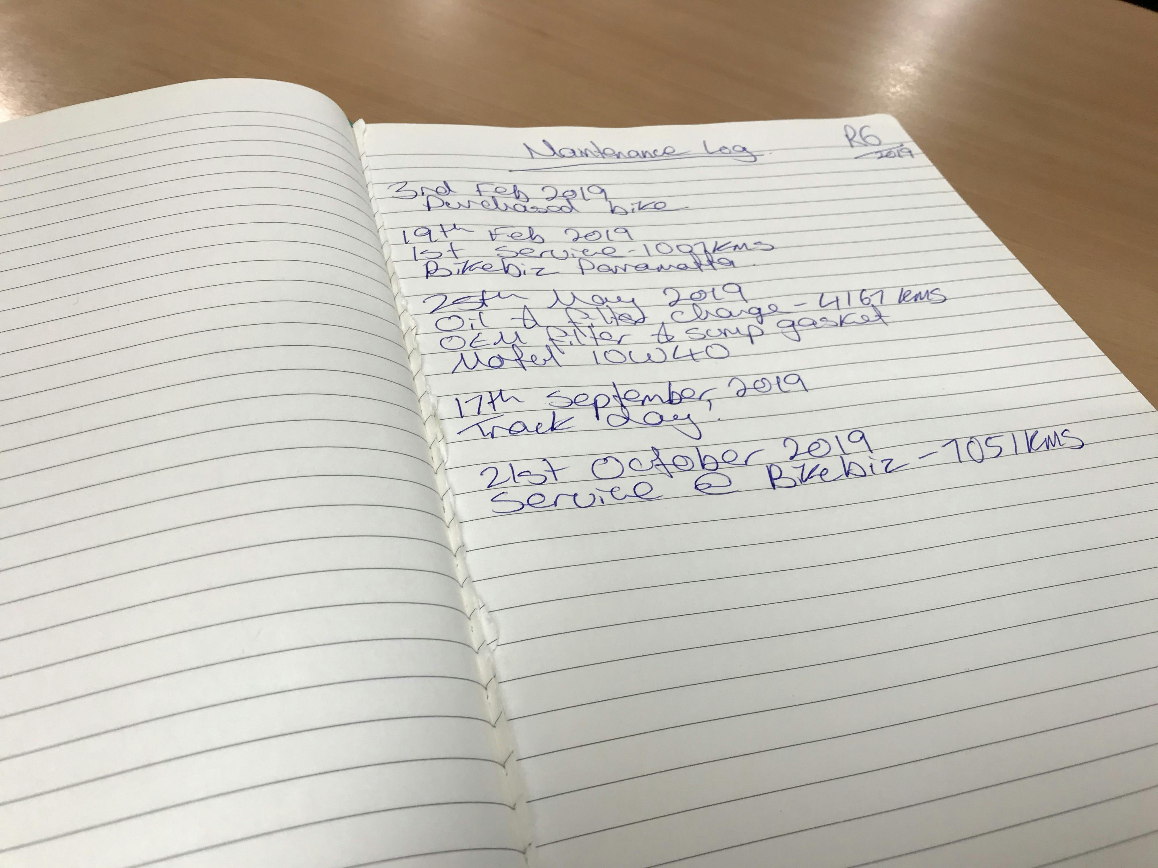 A hand written motorcycle maintenance log