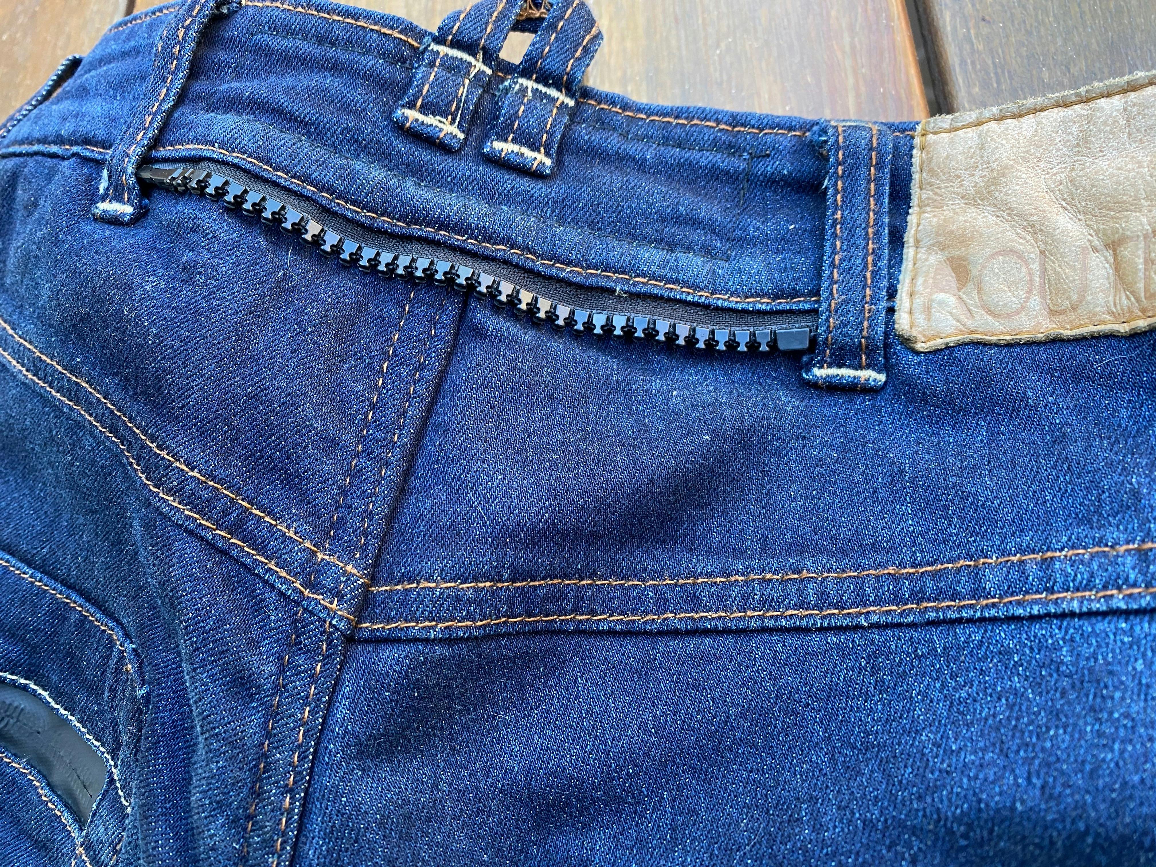 part-length zip at the back of the waist on the back of a pair of blue merlin mason jeans